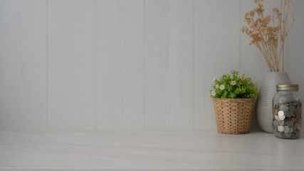 Fototapeta premium Close up view of simple copy space with decorations and coin jar on marble desk