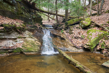 A waterfall running down a rock slide in an evergreen forest in Ohio.