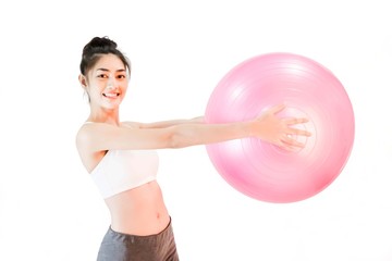 Young beautiful asian woman wearing a white tank top Exercise with pink yoga ball isolated on white background