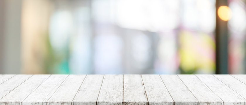 Empty wood table top and blurred of window interior restaurant banner mock up abstract background - can used for display or montage your products.