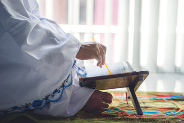 Hand of senior muslim woman holding pointer stick