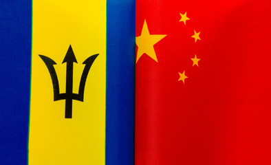 fragments of the national flags of Barbados and China in close-up