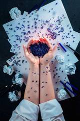 Spilled letters in hands of a writer, flat lay with hands, creative workplace