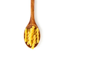 Raw Italian pasta in wooden spoon on white background. Food and drink concept. Top view. Copy Space