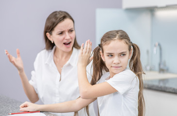 Mother scolds her teenage daughter, girl ignoring her mom and shows stop gesture. Family relationships