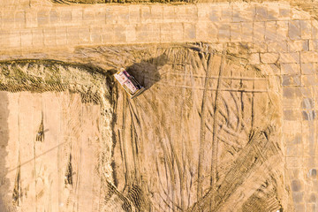 aerial drone view of bulldozer working at building site. leveling ground of construction site 