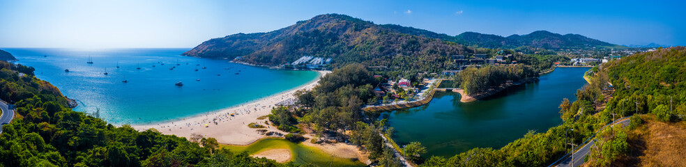 Aerial panorama of Nai Harn beach on the island of Phuket in Thailand during sunny day - obrazy, fototapety, plakaty