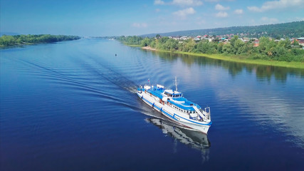 Aerial view of the boat moving along the channel of the river of Volga near the city of Samara....