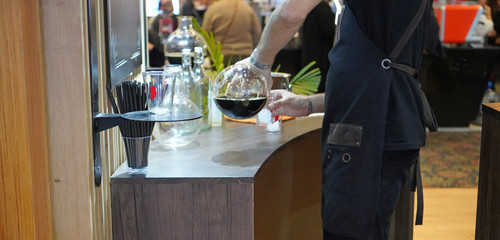 Man preparing and filling coffee