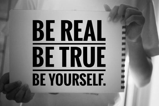 Inspirational quote - Be real. Be true. Be yourself. With young girl holding white paper book sign with reminder notes. Self confident motivational words concept in black and white background.