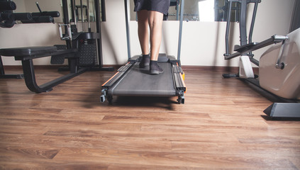 Obraz premium Boy running on the treadmill in the gym.