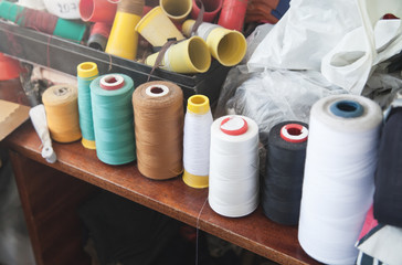 Colorful many sewing threads on the table.