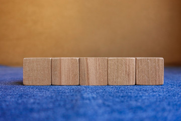 Wooden cubes on colored background.