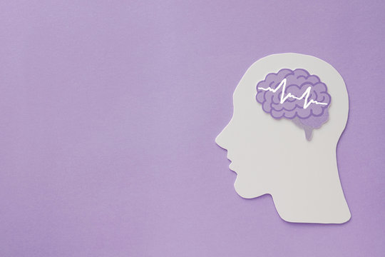 encephalography brain paper cutout on purple background, Epilepsy and alzheimer awareness, seizure disorder, mental health concept