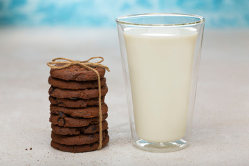 Healthy breakfast. A glass of milk and a stack of chocolate chip cookies.