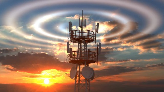 Cellular telecommunications tower with radio waves visible against scenic sunset sky. Modern cellular telecommunications towers can cover a wide range of network technologies including modern 4G 5G