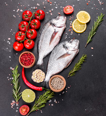 Raw dorado fish with spices cooking on cutting board