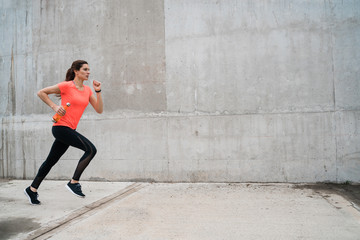 Fototapeta premium Portrait of fitness woman running.