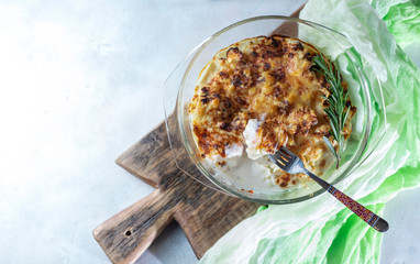 casserole from cauliflower with bechamel sauce in a glass baking dish.