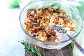 casserole from cauliflower with bechamel sauce in a glass baking dish.