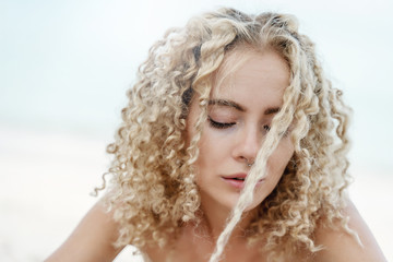 Fototapeta premium Head portrait shot, young beautiful curly sexy blonde, beauty and fashion, trendy hair style