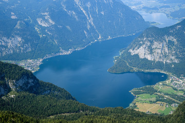 Aerial view from the top of the mountain to a mountain lake surrounded by Alpine mountains. Hallstatt, Austria.
