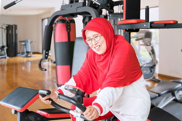 Senior woman doing workout on exercise bike