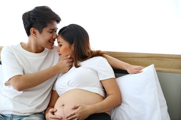 Young man taking care of young wife while pregnant