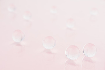 Abstract pastel pink cells background -  transparent glass spheres on soft light pink color, blur.