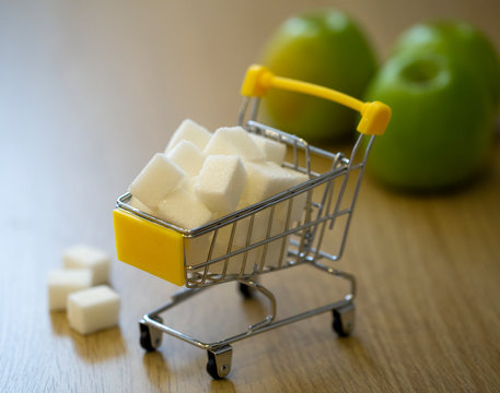 sugar in a grocery cart in light colors with partial blurring. conceptual photo about the harm of sugar to the body