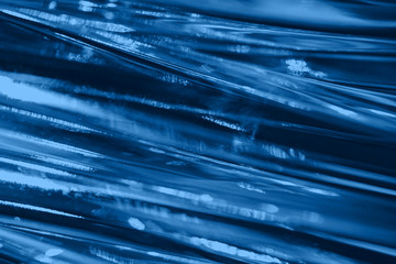 Abstract blurred soft focused futuristic dark blue glass wavy background. 2020 trend color concept