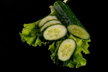 Cucumber slices against black background	