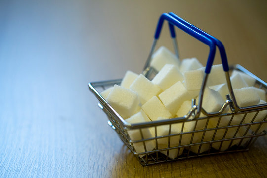 sugar in a grocery cart in light colors with partial blurring. conceptual photo about the harm of sugar