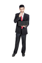 Young businessman looking at his laptop
