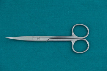 Basic surgical instrument stainless steel curve operation scissors s/s isolated on surgical green...
