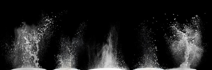White powder explosion cloud against black background.White dust particles splash