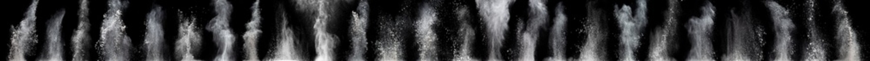 White powder explosion cloud against black background.White dust particles splash