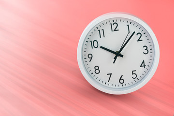 Mechanical watch on a light pink background. The slope of the horizon line. Exact time. Space for text. Soft toning of the image.