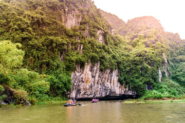 Tam Coc National Park - Tourists traveling in boats along the Ngo Dong River at Ninh Binh Province,...