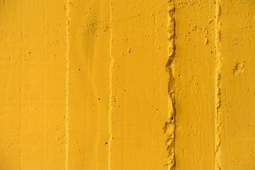 Yellow concrete wall texture with interesting surface.Close-up.