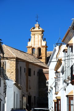 Whitewashed townhouses with a church to the rear, Osuna, Spain.