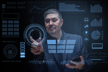 An engineer works with computer technology in a modern laboratory with a virtual interface