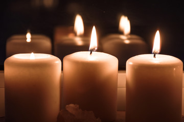 Burning candles on the windowsill. Cozy summer evening at home