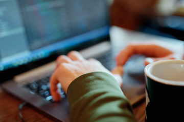 closeup mans hands freelancer sitting in cafe working laptop
