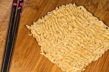 raw chinese noodles with chop sticks