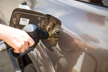 man refueling a car