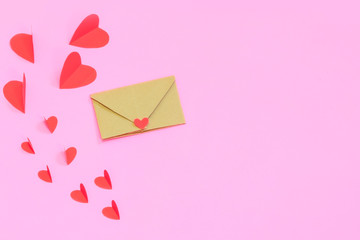 Love Valentine's day concept. Red hearts on a pink pastel background to copy space.