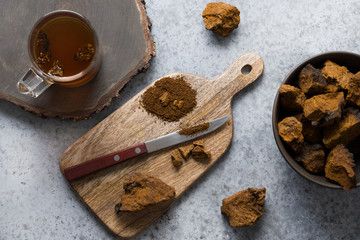 Chaga infusion beverage in cup. Trendy Russian healthy infusion.
