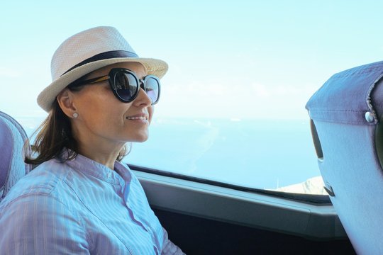 Woman Passenger In Hat Sitting In Bus Looking Out The Window