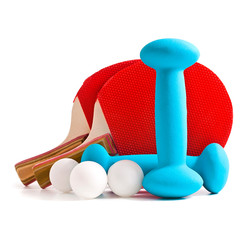 Blue fitness dumbbells and red table tennis rackets isolated on a white background.